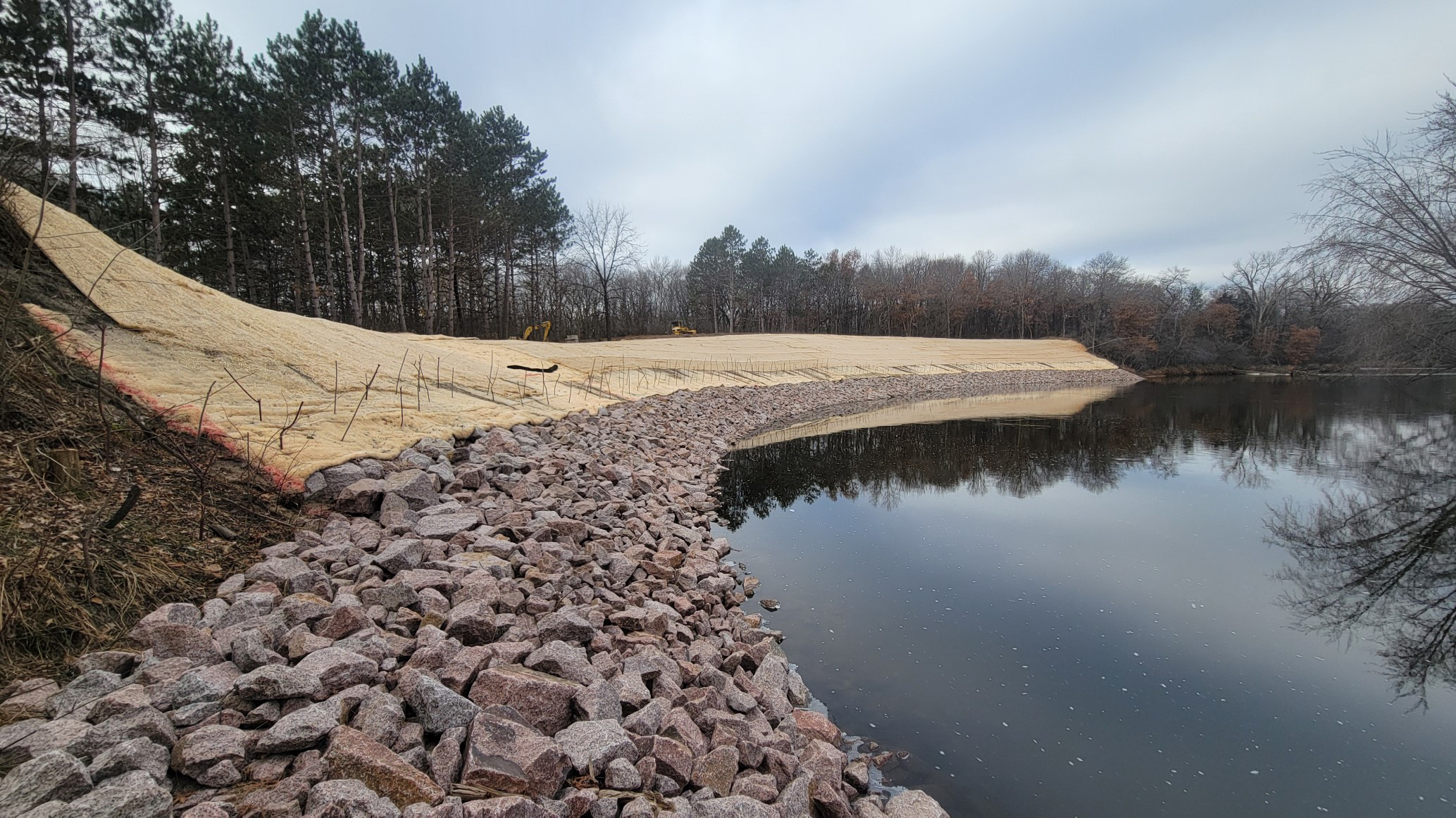 After construction, view of restored riverbanks with riprap installed.